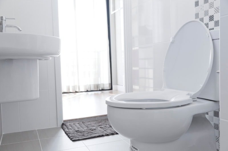 Common Sewer Odors in Your Home: What’s That Smell? White toilet with water closet look outside.